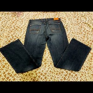 Lucky Brand flare jeans, intentionally distressed.  Stitching on rear pockets.